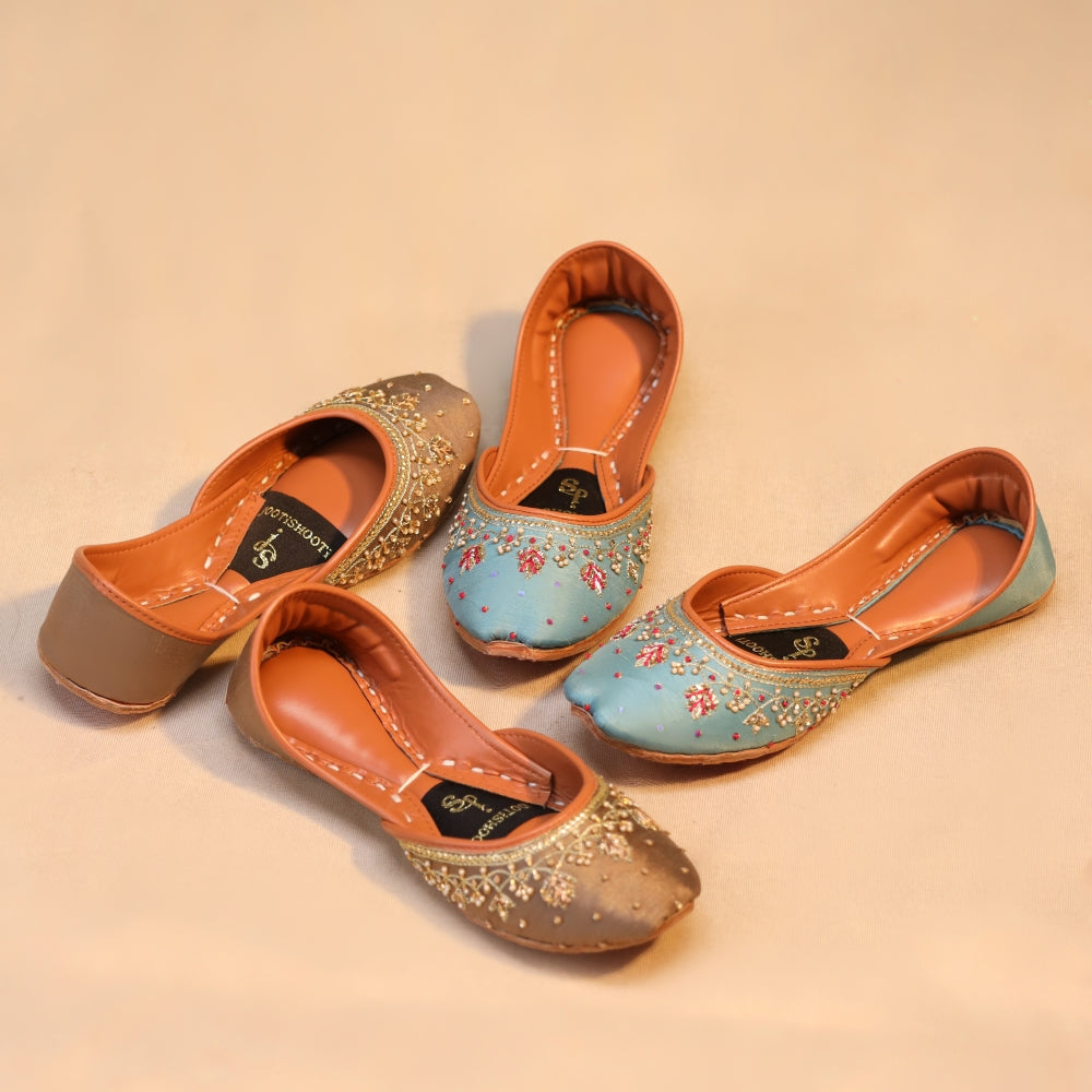 Pair of decorative khussas on a beige background