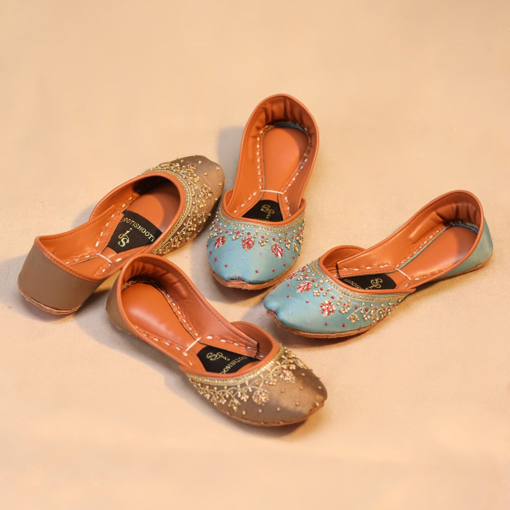 Pair of decorative khussas on a beige background