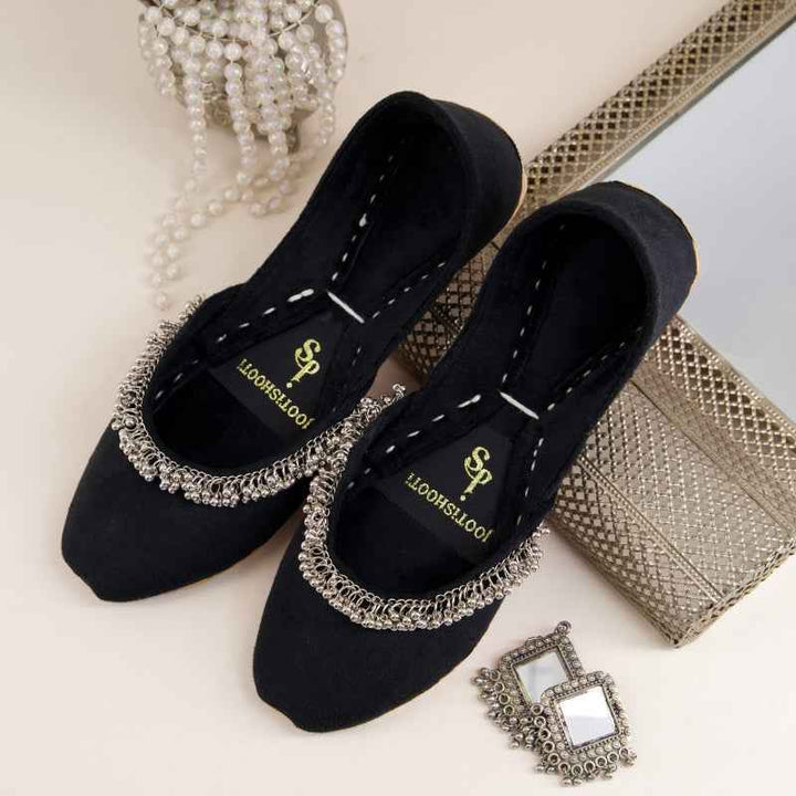 “Close-up of Beaded Halo Black Khussa shoes highlighting leather texture and subtle beadwork”